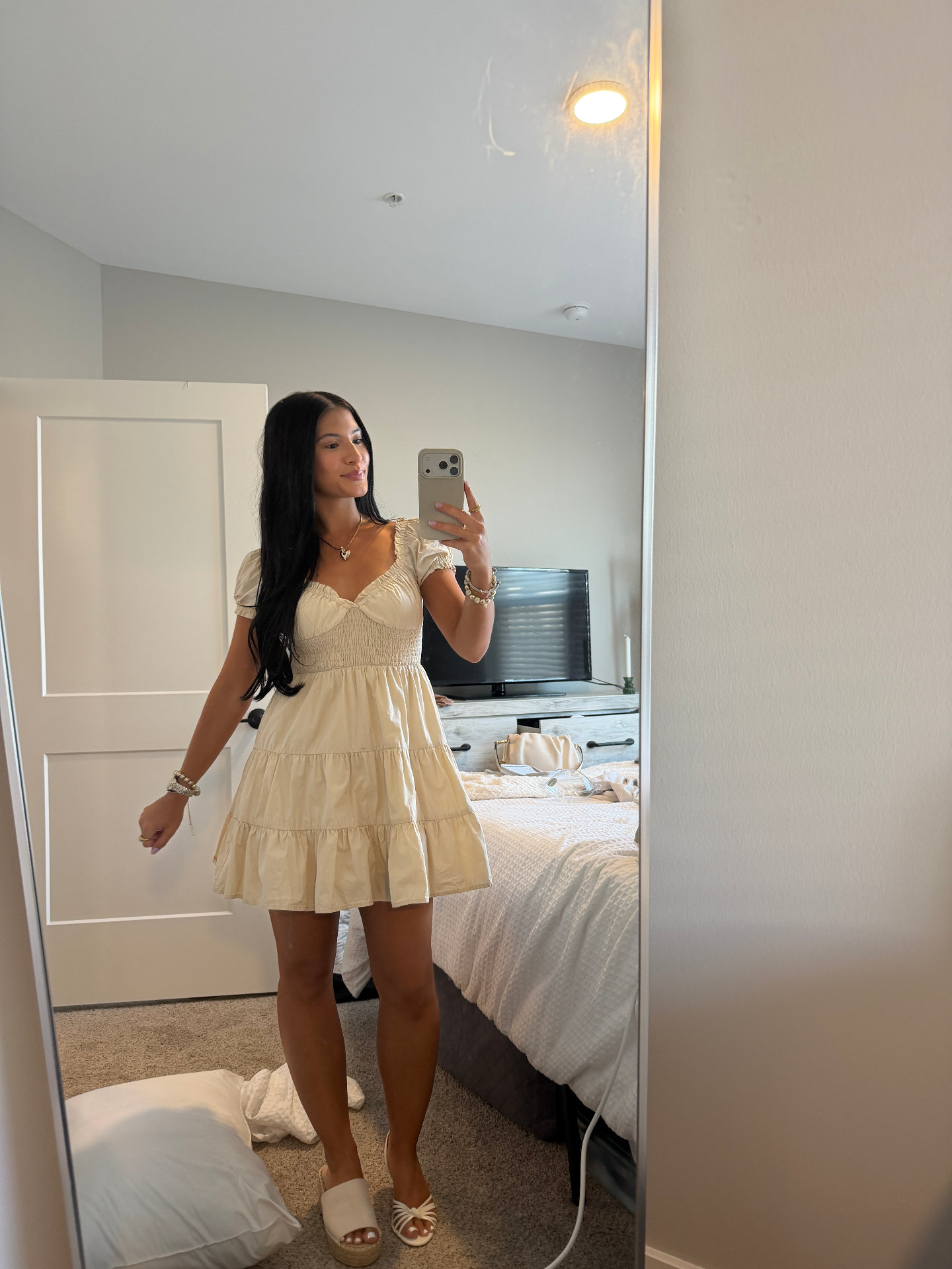 Bronze Room client glowing in a cream tiered mini dress