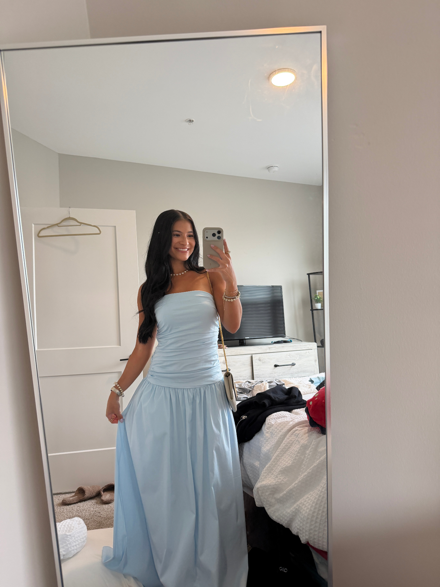 Mirror selfie of a client in a light blue gown with a soft, natural Bronze Room glow