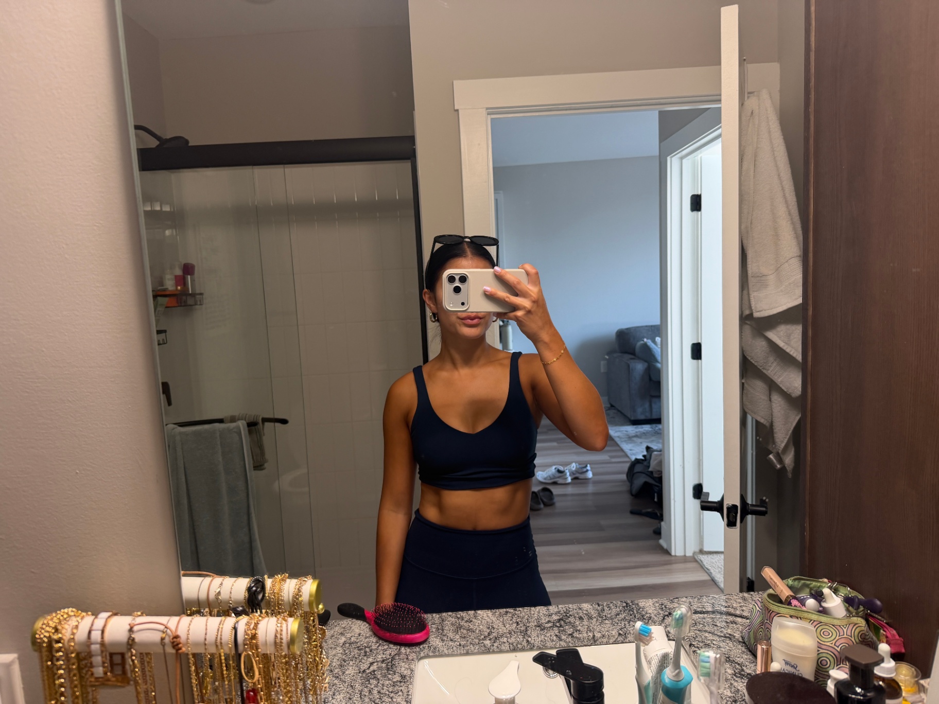 Deep, even Bronze Room tan on a client in a navy set